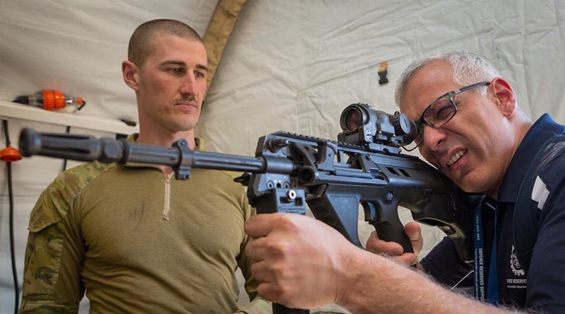 Sumit Sachdeva is briefed on the capabilities of the EF-88 rifle by Leading Aircraftman Breen Canning, from No. 3 Security Forces Squadron, during a visit to Shoalwater Bay Training Area as part of Exercise Boss Lift – Talisman Sabre 2019. Photo by Corporal Nicci Freeman.