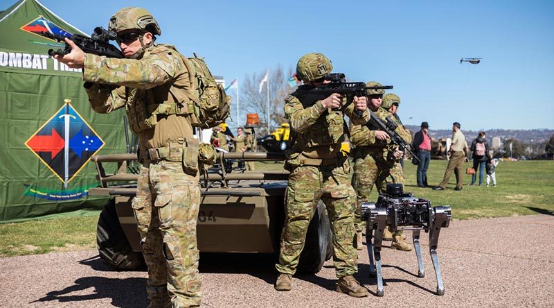 Australian Army soldiers from the Combat Training Centre are joined by Mule (rear) and Ghostrobotics (right) unmanned ground vehicles, as well as a Black Hornet nano UAV in a display of human-machine teaming during Army Demonstration Day at Russel Offices. Photo by Corporal Sebastian Beurich.