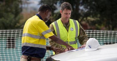 Australian Army soldier Sergeant Chris Renew from 19th Chief Engineer Works looks over plans with local contractor Vuksich and Borich Project Manager, Suvinay Basawaiya at Blackrock Camp in Nadi, Fiji. Photo by Leading Seaman Craig Walton.