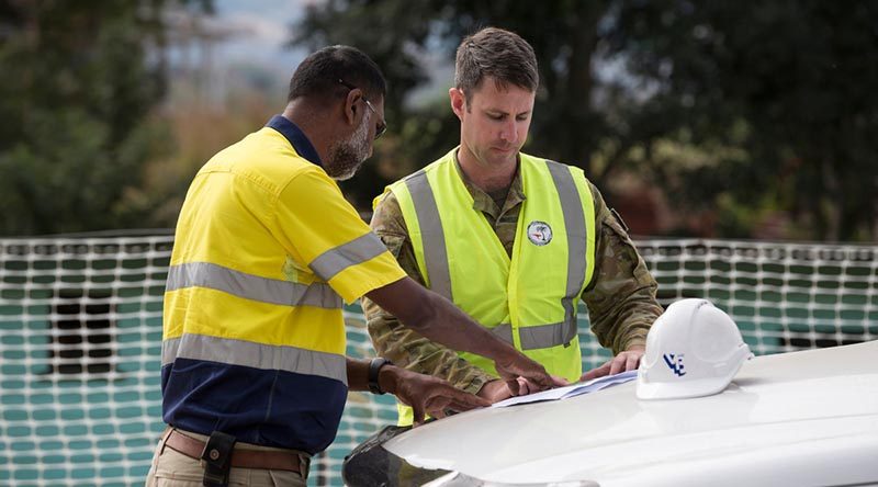 Australian Army soldier Sergeant Chris Renew from 19th Chief Engineer Works looks over plans with local contractor Vuksich and Borich Project Manager, Suvinay Basawaiya at Blackrock Camp in Nadi, Fiji. Photo by Leading Seaman Craig Walton.