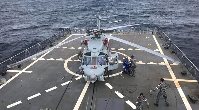 HMAS Hobart’s embarked MR-60R helicopter ‘COBRA 16’ during first-of-class flight trials off the east coast off Australia. Photo by Lieutenant Commander Sidney Raper.