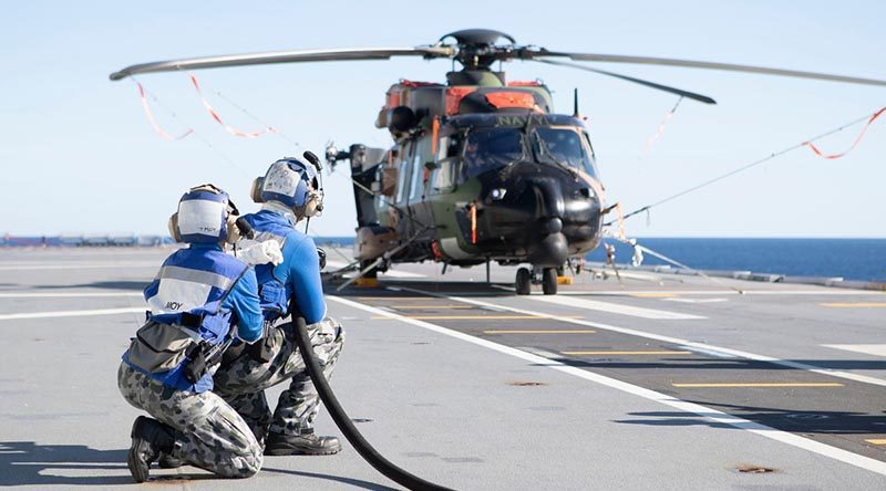 HMAS Canberra's flight deck team conduct crash-on-deck training with a grounded MRH-90 helicopter during Exercise Talisman Sabre 2019. Defence made no mention of the fleet-wide MRH90 grounding until asked by media nearly two weeks after this photo was published. Photo by Leading Seaman Richard Cordell.