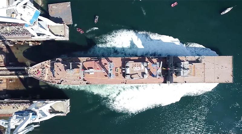 NUSHIP Stalwart slips into the water in Ferol, Spain, during her well-attended ceremonial launch. Navantia drone image.