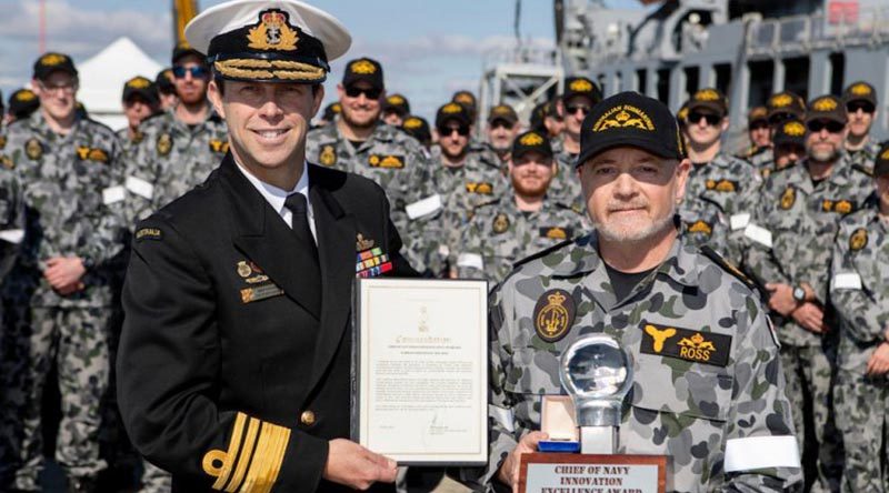 Chief of Navy, Vice Admiral Michael Noonan presents Warrant Officer Paul Ross with a Commendation and Innovation award in front Submarine Force personnel on Diamantina Pier at Fleet Base West, Western Australia. Photo by Leading Seaman Richard Cordell.