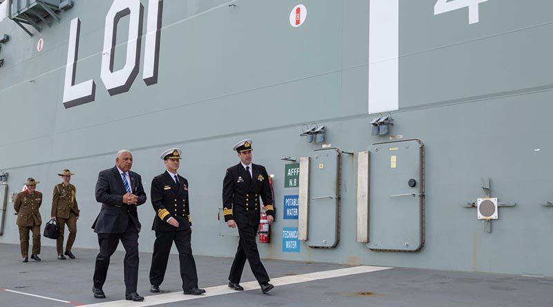 Prime Minister of the Republic of Fiji Josaia Vorege 'Frank' Bainimarama with Vice Chief of the Australian Defence Force Vice Admiral David Johnston, and Executive Officer HMAS Adelaide Commander Jace Hutchison on a tour of HMAS Adelaide at Fleet Base East, Sydney. Photo by Able Seaman Leo Baumgartner.