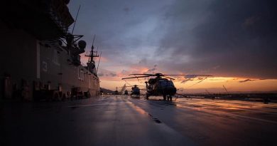 HMAS Adelaide and her embarked helicopters bask in a Solomon Islands sunset.