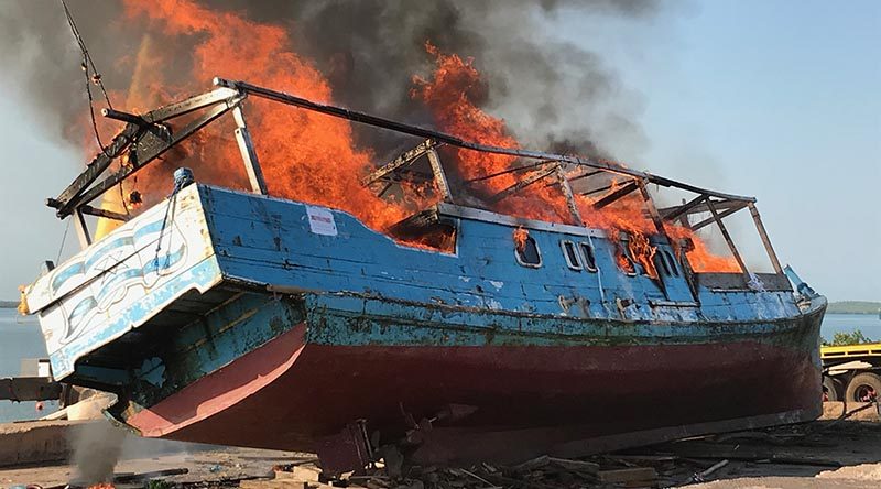 An Indonesian fishing boat, caught illegally fishing in Australian waters, is destroyed by fire in Darwin. Australian Border Force photo.