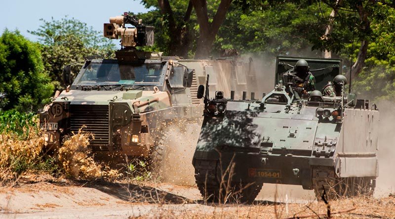 An Australian Army Bushmaster conducts tactical mounted manoeuvres with an M113/AS1 from the Tentara Nasional Indonesia Army (TNI-AD) at Dodiklatpur training base, East Java. Photo by Corporal Shane Kelly.