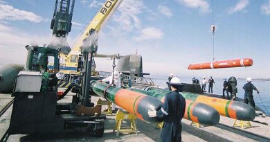 HMAS Dechaineux takes on training torpedoes at the ammunition wharf at HMAS Stirling. Photo by Able Seaman Photographer Phillip Cullinan.