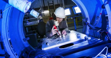 Steven De Candia, a PhD candidate and mechanical engineer, prepares instrumentation for an experiment on a submarine structural test model at Defence Science and Technology facility, Fishermans Bend, Melbourne. Photo by Lauren Larking.