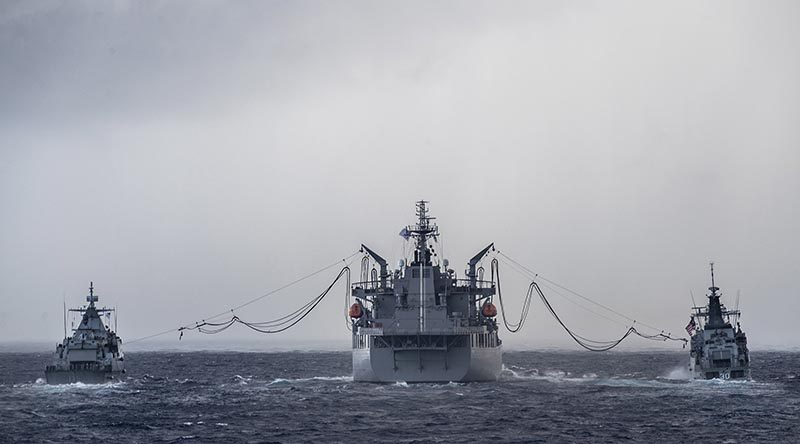 HMAS Sirius conducts a dual replenishment at sea with Malaysian ships KD Lekiu and KD Kelantan during her East Asia deployment. Photo by Leading Seaman Tara Byrne.