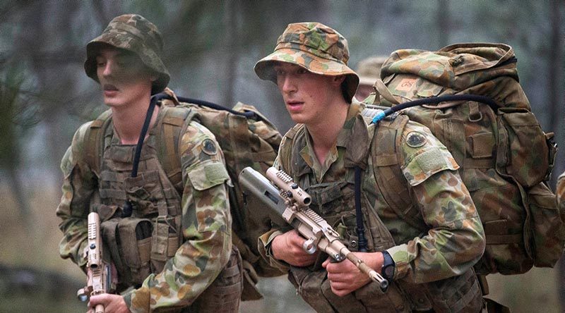 Australian soldiers march with packs at the Royal Australian School of Infantry in Singleton. Photo by Sergeant Janine Fabre.