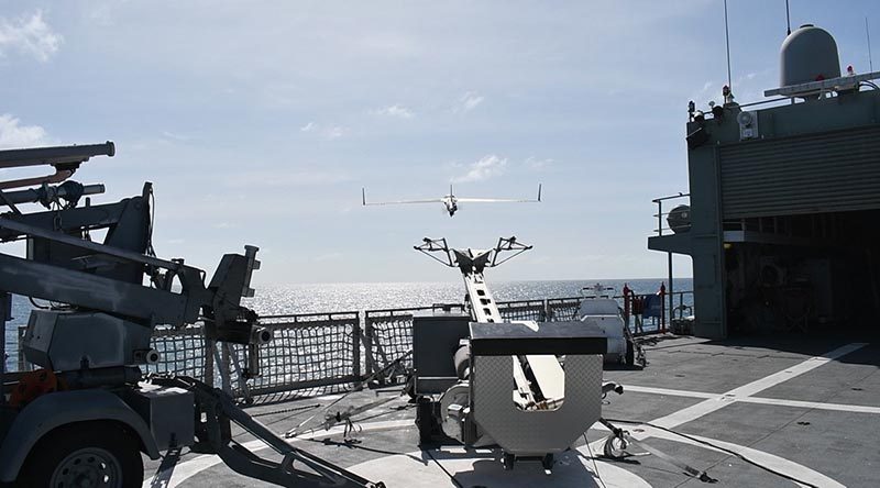 A ScanEagle remotely piloted aircraft is launched by pneumatic catapult from the flight deck of HMAS Leeuwin during first-of-class flight trials in real-world conditions on the ship's current Asian deployment. Photo by Lieutenant Michael Azoury.