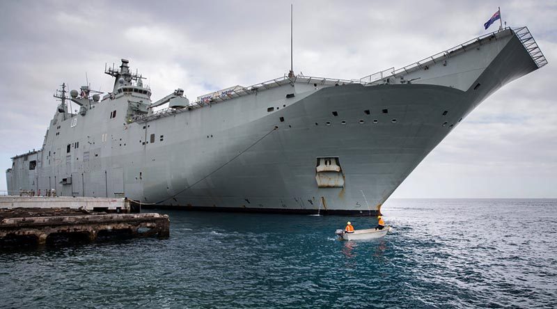 Vuna Wharf employees provide support to HMAS Adelaide in Nuku'alofa, Tonga. Photo by Corporal Jessica de Rouw.