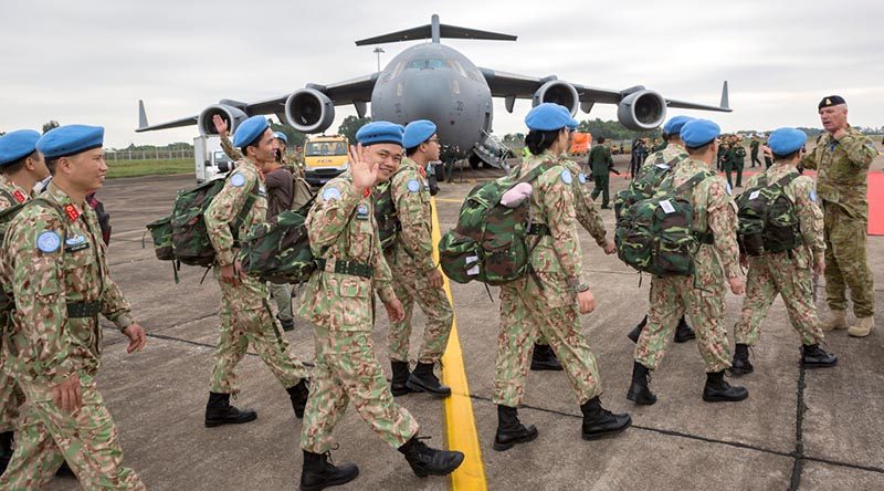 Members of a Vietnam People's Army medical team board a Royal Australian Air Force C-17A Globemaster in Hanoi, Vietnam, for transport to the Vietnamese Field Hospital supporting the United Nation's mission in South Sudan. Photo by Sergeant Christopher Dickson.