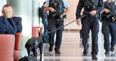 AFP officers with short-barrelled rifles, body-worn cameras and explosives detection dog on patrol at an Australian airport. AFP photo.