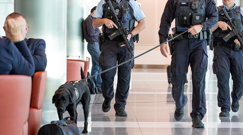 AFP officers with short-barrelled rifles, body-worn cameras and explosives detection dog on patrol at an Australian airport. AFP photo.