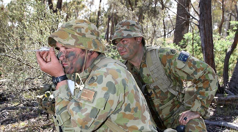 Staff Cadet Neil Fletcher shoots a compass bearing, supervised by Sergeant Wane Swan, at the Majura Training Area. Photo by Corporal Max Bree. Mid Cap: Sargent Wane Swan is an instructor of Third Class cadets at the Royal Military College, Duntroon. Third Class is the initial six months of training that teaches cadets basic soldier and section leadership skills.