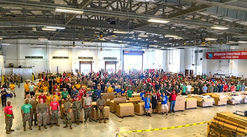 Service members and volunteers who helped build air-drop supply bundles at Andersen Air Force Base, Guam, for Operation Christmas Drop 2019. US Air Force photo by Staff Sergeant Kyle Johnson.