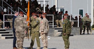 Outgoing Force Commander of the Multinational Force and Observers (MFO) in the Sinai, Australian Army Major General Simon Stuart hands over the MFO flag to Ambassador Stephen Beecroft, Director General MFO, during the change of command parade in Sinai, Eygpt. Photo by Captain Jarrad Baldwin.