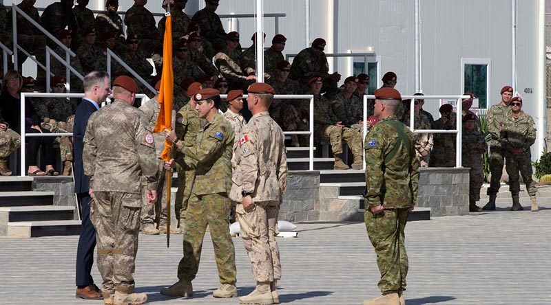 Outgoing Force Commander of the Multinational Force and Observers (MFO) in the Sinai, Australian Army Major General Simon Stuart hands over the MFO flag to Ambassador Stephen Beecroft, Director General MFO, during the change of command parade in Sinai, Eygpt. Photo by Captain Jarrad Baldwin.