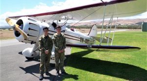 Cadets Sam Lotfi and Josh Bishop with the Waco biplane. Image by FLTLT(AAFC) Ian Harlow, 906 Aviation Training Squadron.