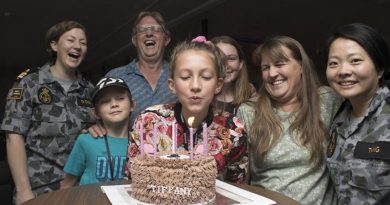 The Bragg family celebrate Tiffany's 12th birthday with their new Navy friends at the HMAS Harman bushfires evacuation centre.Photo by Lieutenant Ben Robson.