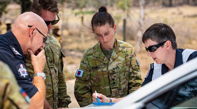 Lieutenant Matilda Connell and Corporal Trent Jones from the 3rd Combat Engineer Regiment conduct map reconnaissance with Deputy Incident Controller Emma Conway and Commander Mitch Simmons from the Country Fire Authority, to assess fire damage in Omeo, during Operation Bushfire Assist. Photo by Private Madhur Chitnis.