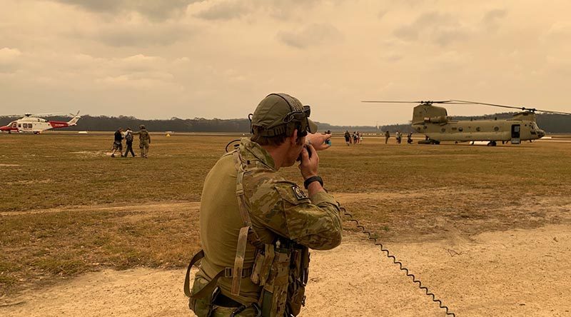 A 4 Squadron combat controller assists with the evacuation of civilians and the departure of Defence assets from Mallacoota airfield. Photo by Squadron Leader Chris Sharp.