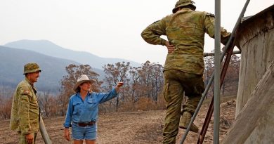 Australian Army soldiers Private Daniel Muntz (left) and Private Brendan Harvey deliver 9000 litres of water to remote-property owner Donna Thomson, who's water pump was destroyed by bushfires, leaving her, her family and her livestock dangerously short of water. The soldiers are from the Brisbane-based 7th Combat Service Support Battalion. Phot and story by Sergeant Dave Morley.
