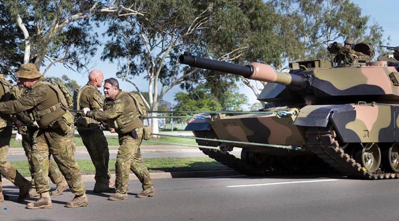 Soldiers of 2nd Cavalry Regiment in Townsville pull a 62-tonne Abrams tank – for PT.