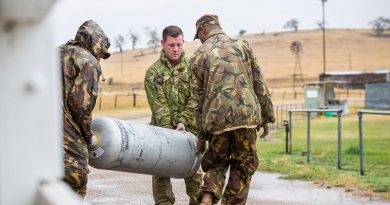 3rd Combat Engineer Regiment's Sapper Luke Simmonds helps Papua New Guinea Defence Force soldiers move a gas bottle at the Benambra Recreation Area. Photo by Corporal Sebastian Beurich.