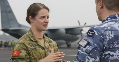 Army Corporal Ashton Brooks, from the Joint Movement Control Office, liaising with an Air Force member during the dispatch of supplies. Photo by Corporal Kylie Gibson