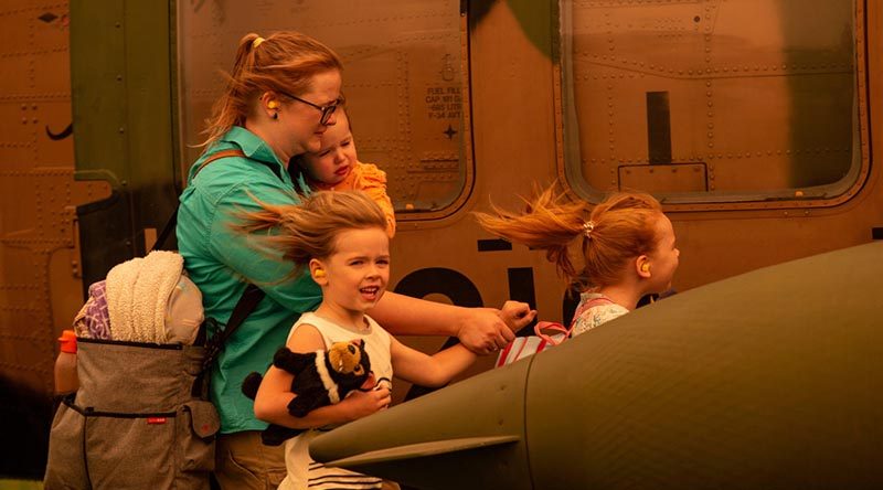 A family boards an Australian Army Blackhawk helicopter at Omeo Showgrounds, Victoria for evacuation to RAAF Base East Sale, during Operation Bushfire Assist 19-20. Photo by Corporal Nicole Dorrett.