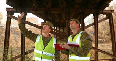 Army sappers Lance Corporal Rick Williams, left, and Corporal Ross Lorenz, of the 5th Engineer Regiment, inspect a fire-damaged bridge in Cobargo. Photo by Sergeant Max Bree.