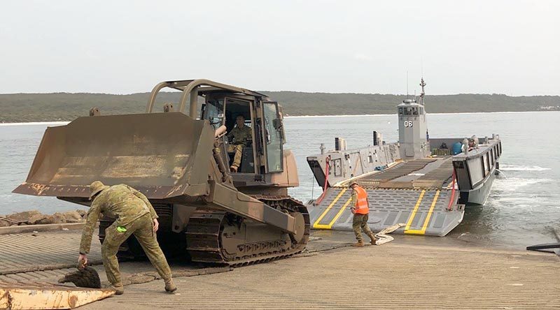 A bulldozer is landed at HMAS Creswell, Jervis Bay, from HMAS Adelaide.