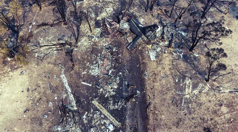 An aerial photo of the C-130 crash site, with the charred remains of the tail section at the end of a long skid uphill to its final resting place. This tail section is the largest piece of wreckage left after a very violent crash. NSW Police photo. 