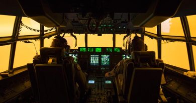 The flight deck glows orange from bushfire smoke as the crew of a Royal Australian Air Force C-130J Hercules attempts to land at Merimbula airfield to deploy fire and rescue crews to assist fighting the bushfires. Photo by Sergeant Christopher Dickson.