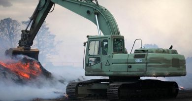 Sapper Mathias Beddie, 2nd Combat Engineer Task Group – NSW, pulls-down piles of burning mulch so that bulldozers and graders may spread it for firefighters to extinguish with water. The piles are too dense to extinguish without first being spread and could otherwise smoulder for weeks and remain a fire hazard. Photo by Major Cameron Jamieson.