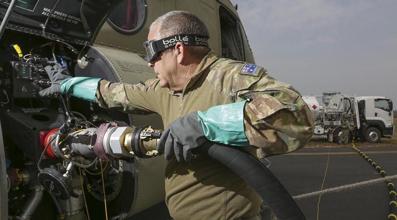 Sergeant Ian MacGregor refuels a Chinook helicopter at at RAAF Base East Sale in preparation for a mission during Operation Bushfire Assist. Photo by Corporal Kylie Gibson.