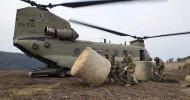 Soldiers from the 7th Battalion, the Royal Australian Regiment, move a bale of hay for livestock delivered by an Australian Army CH-47F Chinook near Jackson’s Crossing, Victoria: Photo by Private Michael Currie.