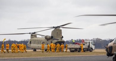 Victorian CFA firefighters arrive on an Australian Army CH-47 Chinook helicopter at Mallacoota. Photo: Corporal Nicole Dorrett.
