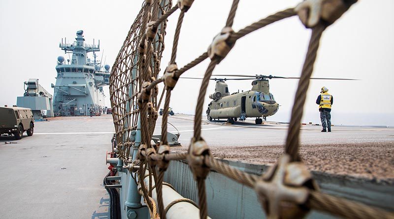 An Australian Army CH-47F Chinook helicopter loads stores on the flight deck of HMAS Adelaide during Operation Bushfire Assist. Photo by Petty Officer Tom Gibson.