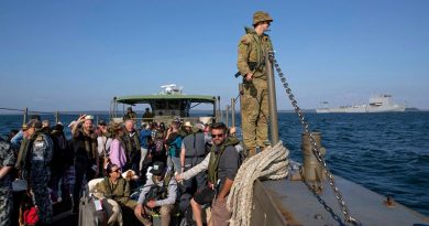 An LCM8 transits from HMAS Choules to HMAS Cerberus to disembark evacuees from Mallacoota during Operation Bushfire Assist 19-20 as the ship takes on supplies via the ship's MRH-90 helicopter. Photo by Petty Officer Helen Frank.