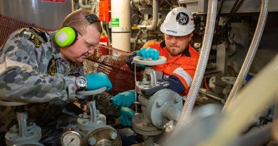 Leading Seaman Mark Curtis and Shadbolt contractor Scott Reid perform maintenance on the sewage-treatment plant of HMAS Adelaide during Operation Bushfire Assist 19-20. Photo by Petty Officer Tom Gibson.