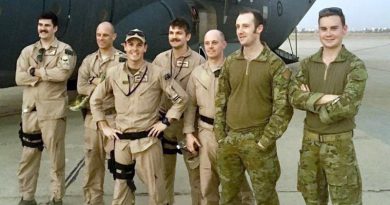 The crew of Mambo 21 stand in front of a Royal Australian Air Force C-130J Hercules at Baghdad International Airport. Flight Lieutenant Brendan Carraro, the aircraft captain, is pictured third from the left (wearing a cap).