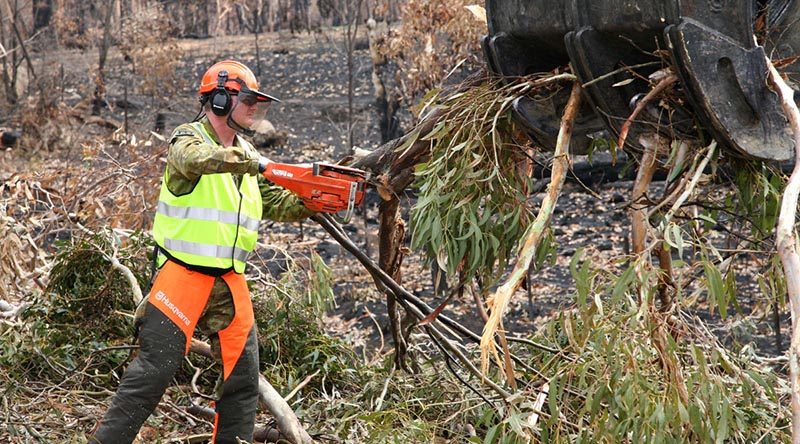 Lance Corporal Damien Ewin reduces bushfire-damaged trees to manageable pieces for disposal during road clearance operations near Ilford, NSW. Lance Corporal Ewin is an Australian Army Reserve engineer, from the 5th Engineer Regiment, – and also owner of Premier Defence Agencies and long-time advertising supporter of CONTACT. Photo by Major Cameron Jamieson