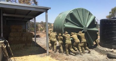 Australian Army soldiers from 16 Regiment Emergency Support Force assist in flushing a contaminated water tank near Lobethal, South Australia.