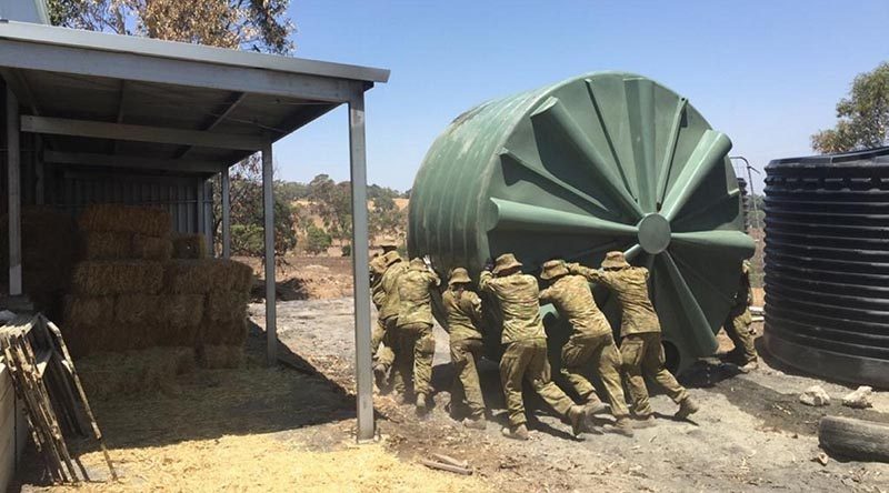 Australian Army soldiers from 16 Regiment Emergency Support Force assist in flushing a contaminated water tank near Lobethal, South Australia.