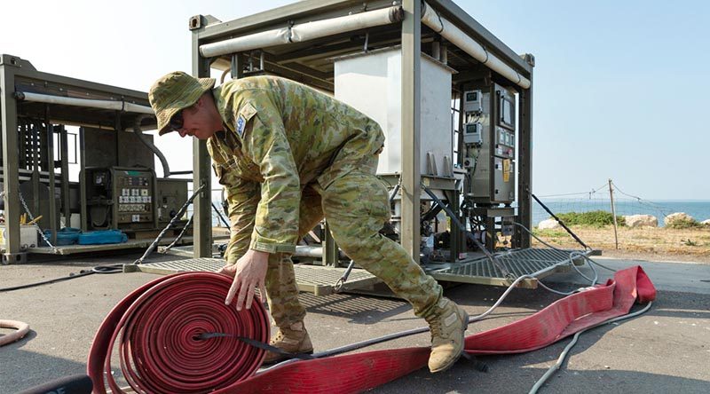 Corporal Luke Jackson from the 6th Engineer Support Regiment assembles an Australian Army mobile water filtration system at the Kingscote town jetty on Kangaroo Island. The mobile plant will turn sea water into drinking water for residents of the island. Photo by Corporal Tristan Kennedy.